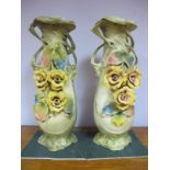 A Pair of Large Bisque Vases, in the Art Nouveau style of flowers and trailing vines, 50.5 cms high.