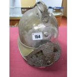 An Early XX Century French Firemans Helmet, in white metal and brass finish, helmet plate loose.