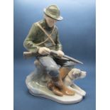 A Royal Copenhagen Figure of A Hunter and His Dog, seated holding a gun, no.1087, c.1980-1984,