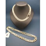 A Two Row Pearl Bead Necklace, the uniform beads knotted to 9ct gold oval cluster clasp, claw set to