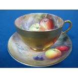 A Royal Worcester Porcelain Teacup and Saucer, painted by Ricketts, signed, with ripening fruit