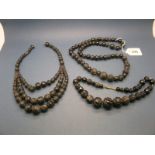 A XIX Century Black Carved Bead Necklace, of three row design (clasp broken); Together with Two