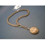 A XIX Century Oval Locket Pendant, with applied monogram, on chunky ropetwist chain.