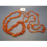 A Long Faceted Amber Bead Necklace, together with an irregular amber necklace, of graduated