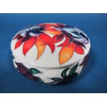 A Moorcroft Pottery Circular Lidded Pot, decorated with the Ruby Red design by Emma Bossons, shape