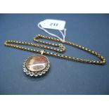 A XIX Century Pendant, the glazed locket front within border of graduated colourless paste, on a