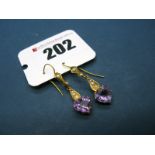 A Pair of Edwardian Amethyst and Seed Pearl Earrings, each heart shape amethyst claw set, on hook