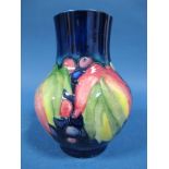 A Moorcroft Pottery Vase, of baluster form, decorated with the Leaf and Berry design, impressed