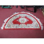 Chinese Tasseled Wool Half Moon Rug, with floral decoration on red ground.