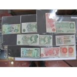 A Collection of Bank of England Banknotes, comprising fourteen £1 and eight 10s notes. A number of
