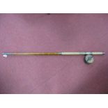 A Two Piece Cane Sea Fishing Rod, together with a "Star Back" wooden fishing reel.