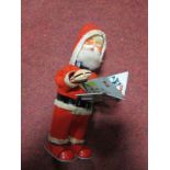 Mid XX Century Japanese Tinplate Clockwork Book Turner Father Christmas, mechanism working.