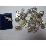 A Curb Link Charm Bracelet, suspending numerous novelty charm pendants, together with loose charms.