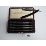 Set of Seven Wade & Butcher 'Special' Cut Throat Razors, each with black bakelite handle, and day of