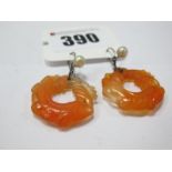 A Pair of Carved Orange Hardstone Drop Earrings, each on chain suspension and hook with applied