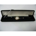 A 9ct Gold Cased Ladies Wristwatch, the white dial with black and red Arabic numerals, within