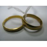 A 22ct Gold Plain Band, together with a patterned band. (2)