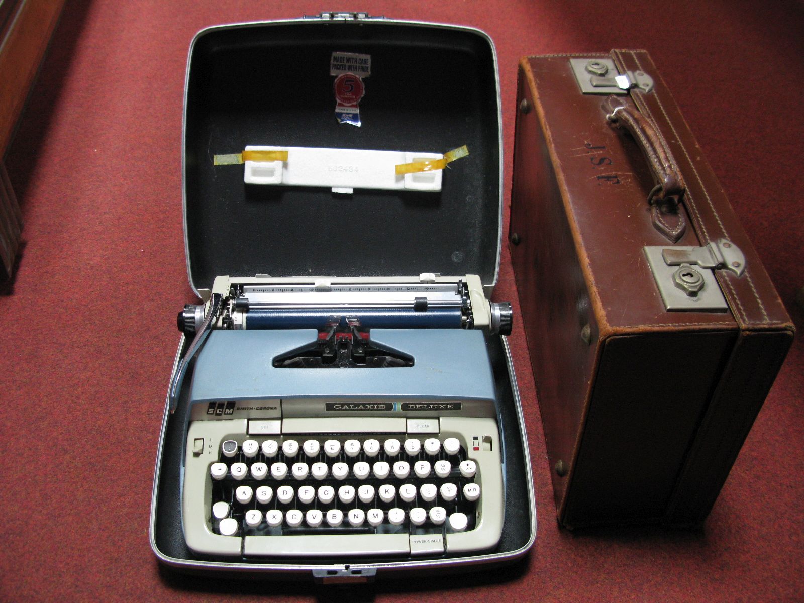 Brown Leather Suitcase, with initials J.S.F, together with a Smith Corona Galaxie Deluxe typewriter.