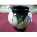 A Moorcroft Pottery Vase, decorated with stylised white roses, designed by Emma Bossons, impressed