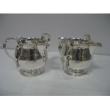 A Pair of Plated Twin Spout Sauce Jugs, each with gadrooned border and leaf capped scroll