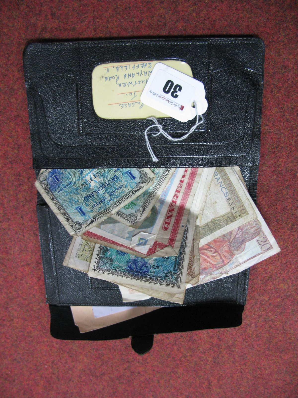 A Collection of Assorted Foreign Banknotes, regularly well circulated, contained in an old wallet.