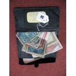 A Collection of Assorted Foreign Banknotes, regularly well circulated, contained in an old wallet.