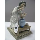 Lladro Figure Group, of a Japanese lady kneeling down by the side of a table. (Boxed)