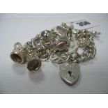 A Curb Link Charm Bracelet, to heart shape padlock clasp, suspending numerous novelty charm