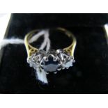 An 18ct Gold Sapphire and Diamond Three Stone Ring, graduated claw set.