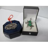 A Silver and Marcasite Brooch, with safety chain; a Marcasite brooch set with green stones. (2)