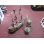 Avery Scales, with brass pans and weights, a carved wooden model galleon. (2)