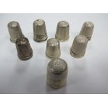 A Collection of Eight Assorted Thimbles, of varying designs, including hallmarked silver. (8)