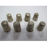 A Collection of Eight Assorted Thimbles, of varying designs, including hallmarked silver. (8)