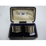 A Pair of Hallmarked Silver Napkin Rings, engine turned, contained in a fitted case.
