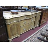 A Victorian Pine Sideboard, serpentine front, moulded edge, fitted with three frieze drawers over