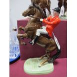 Beswick Pottery, brown rearing horse, with male rider, sporting red coat, impressed number 868,