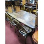Six (Four Singles and Two Carvers) Ercol Comb Back Dining Chairs and Table, on trestle ends.