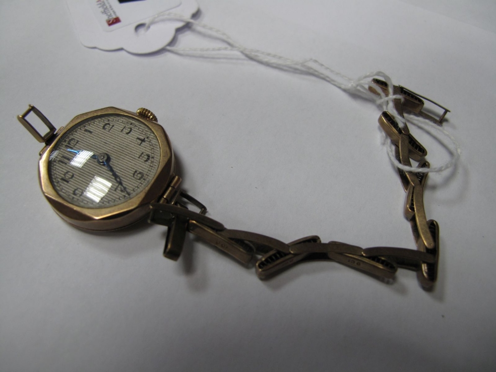 A 9ct Gold Cased Ladies Wristwatch, to expanding bracelet, stamped "9ct" (damaged).