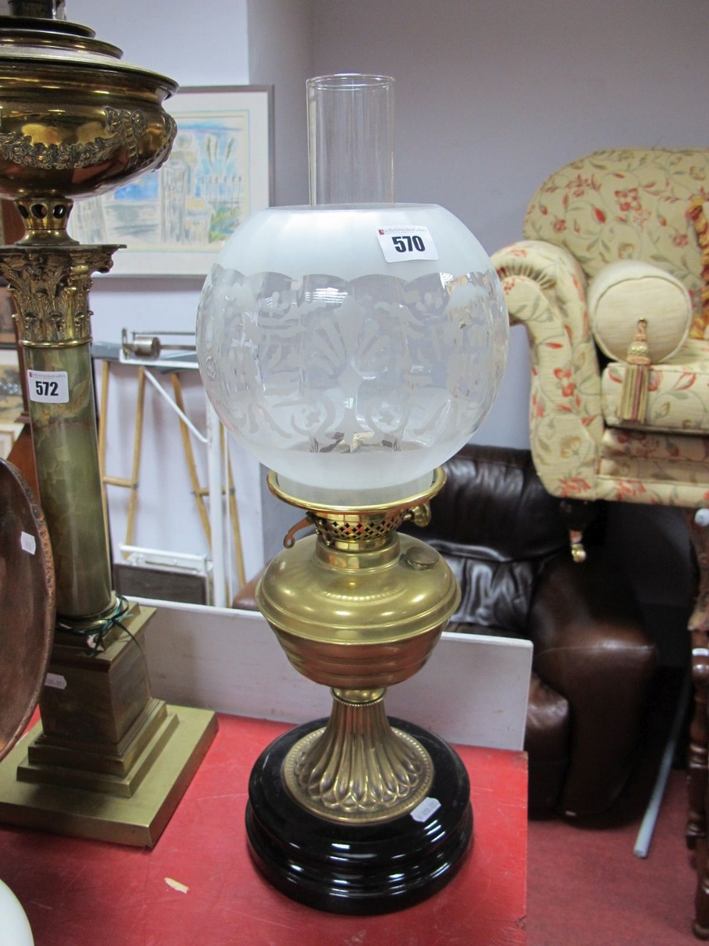 Early XX Century Brass Oil Lamp, on black circular base, with frosted glass shade.