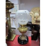 Early XX Century Brass Oil Lamp, on black circular base, with frosted glass shade.