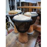 Three Master Djembe African Drums, two with carved stylised decoration to the base, all in need of