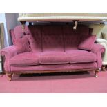 A Three Seater Settee, upholstered in a wine coloured damask, on gadrooned and reeded feet.