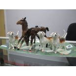 Beswick Pottery, two foals and four hounds.