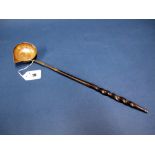 A Georgian Toddy Ladle, the bowl with side spout, inset coin dated 1708 and twisted handle, 36.