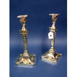 A Pair of Plated Candlesticks, in the classical style, each with rams heads to tapering column, on