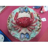 A Circular Pottery Plaque, decorated in the Palissy style with a large central crab within an oyster