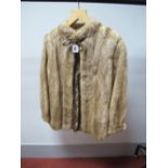 A Blonde Mink Jacket, collarless design with leather bow trim at neck and split sleeve cuffs,