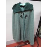 A Green Wool Tweed Elgee of London Cape, with contrasting green corduroy lined hood and frog