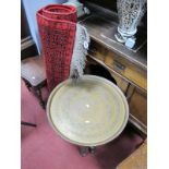An Indian Brass Topped Occasional Table, circular top decorated with star and scroll motifs, on a
