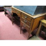 An Early XX Century Walnut Desk, the kneehole below single frieze drawers flanked by a bank of three